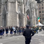 Marching band passes by St. Patrick's Cathedral during the 2023 NYC Saint Patrick's Day Parade.