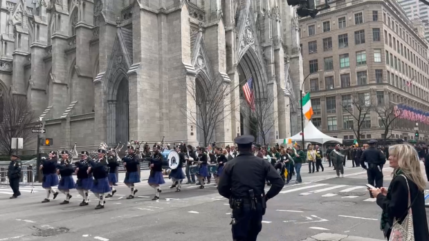 Marching band passes by St. Patrick's Cathedral during the 2023 NYC Saint Patrick's Day Parade.