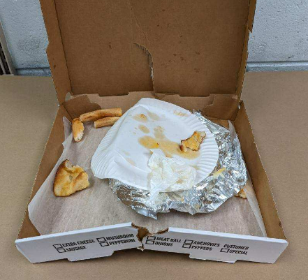 Pizza box with crust that was used to collect DNA evidence linking Rex Heuermann to the Gilgo Beach murders.