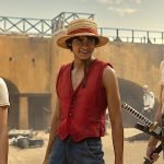The main characters of Netflix's live-action One Piece adaptation, featuring Nami, Luffy, and Zoro, standing together in a scene.