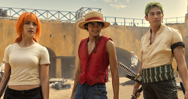 The main characters of Netflix's live-action One Piece adaptation, featuring Nami, Luffy, and Zoro, standing together in a scene.
