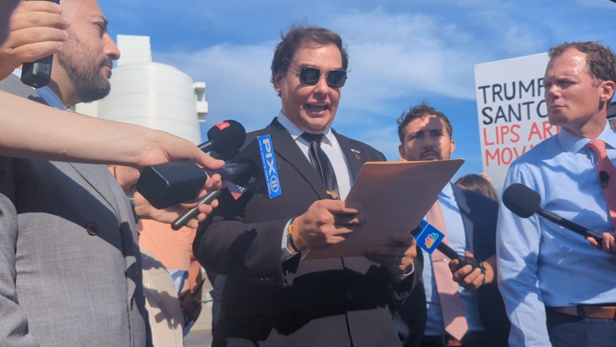 George Santos reads a statement to the press outside the U.S. District Court after pleading guilty to federal charges.