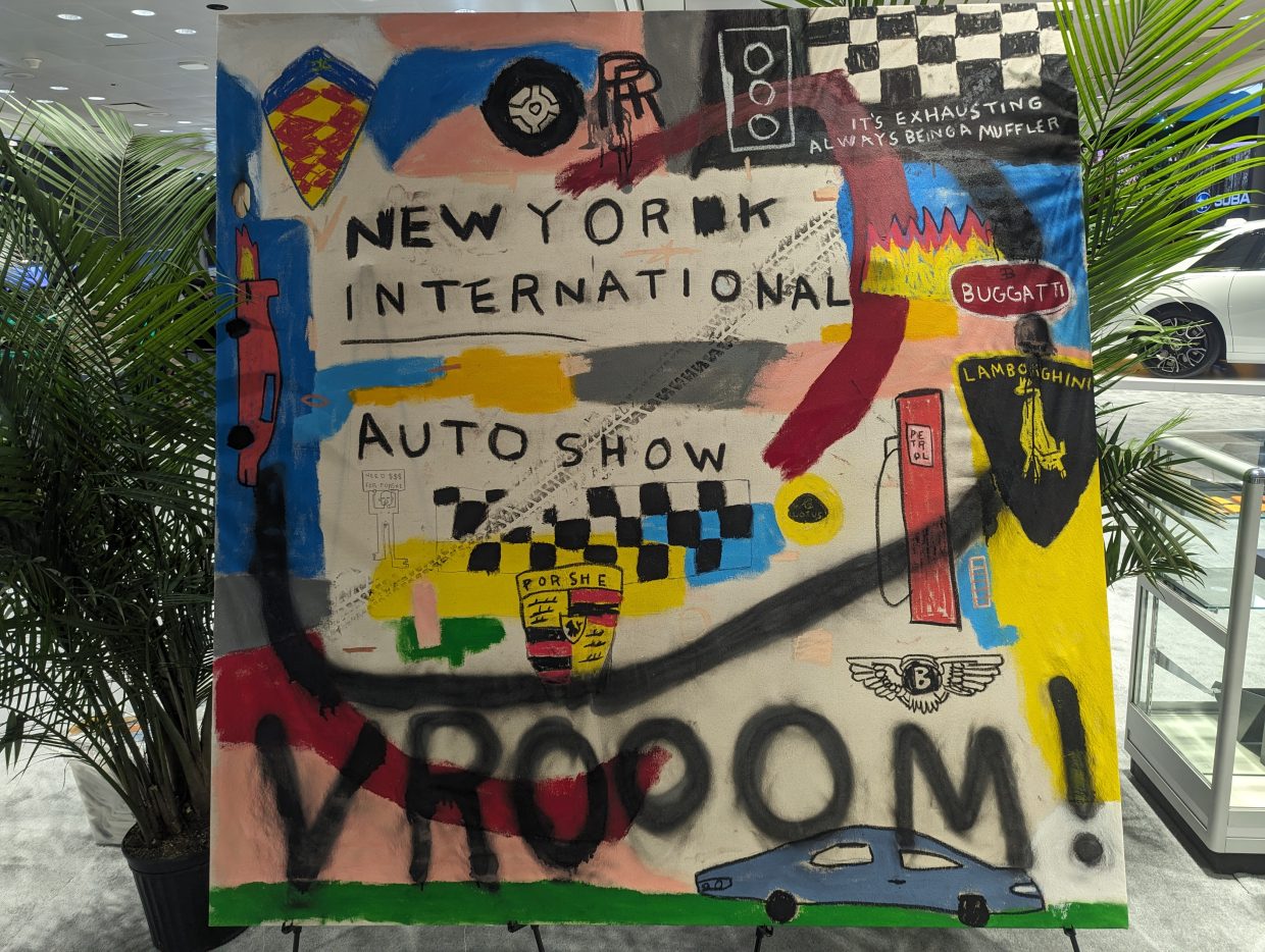 Custom art display at the 2024 New York International Auto Show showcasing various car brands.